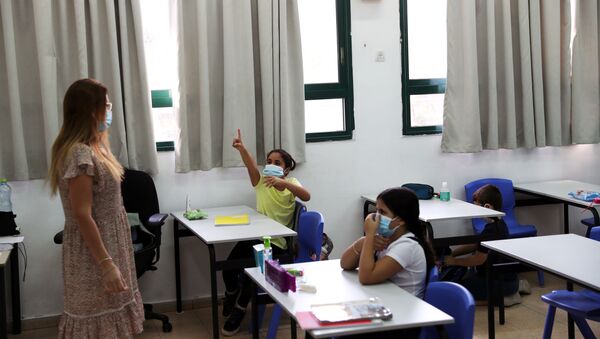 Pupils and a teacher wear protective face masks in a classroom as Israel reopens first to fourth grades, continuing to ease a second nationwide coronavirus disease (COVID-19) lockdown, at a school in Rehovot, Israel November 1, 2020 - Sputnik International
