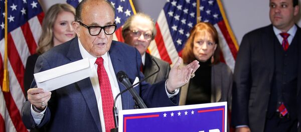 Former New York City Mayor Rudy Giuliani, personal attorney to US President Donald Trump, holds what he identified as a replica mail-in ballot as he speaks about the 2020 US presidential election results during a news conference in Washington, US, 19 November 2020. REUTERS/Jonathan Ernst. Former New York City Mayor Rudy Giuliani, personal attorney to US President Donald Trump, holds what he identified as a replica mail-in ballot as he speaks about the 2020 US presidential election results during a news conference in Washington, US, 19 November 2020. REUTERS/Jonathan Ernst. - Sputnik International