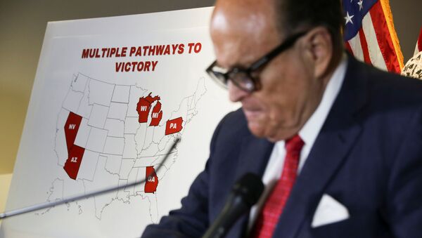 Former New York City Mayor Rudy Giuliani, personal attorney to U.S. President Donald Trump, stands in front of a map of election swing states marked as Trump Pathways to Victory during a news conference about the 2020 U.S. presidential election results held at Republican National Committee headquarters in Washington, U.S., November 19, 2020 - Sputnik International