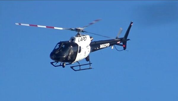 Screenshot image captures helicopter operated by California's Los Angeles Police Department as it makes several passes near Venice Beach in March 2019. - Sputnik International