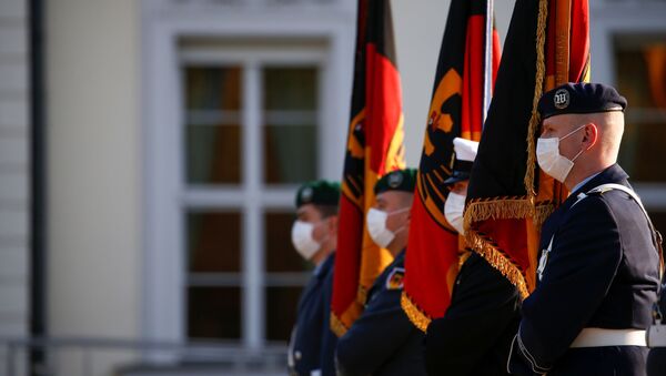 German armed forces Bundeswehr soldiers hold flags outside Bellevue Palace during a swearing-in ceremony, in Berlin, Germany, November 12, 2020.  - Sputnik International