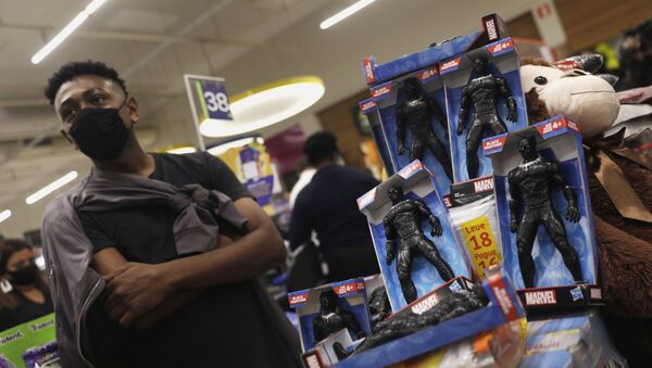 A demonstrator stands next to Black Panther action figures used to block a cashier counter of a Carrefour supermarket during a protest against racism, after Joao Alberto Silveira Freitas was beaten to death by security guards at a Carrefour supermarket in Porto Alegre, in Rio de Janeiro, Brazil, 20 November 2020. - Sputnik International