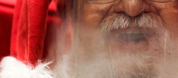 A man who goes by Santa Claus Edi Noel is pictured as he prepares to interact with children by video at NorteShopping mall amid the coronavirus disease (COVID-19) outbreak, in Rio de Janeiro, Brazil, November 13, 2020 - Sputnik International