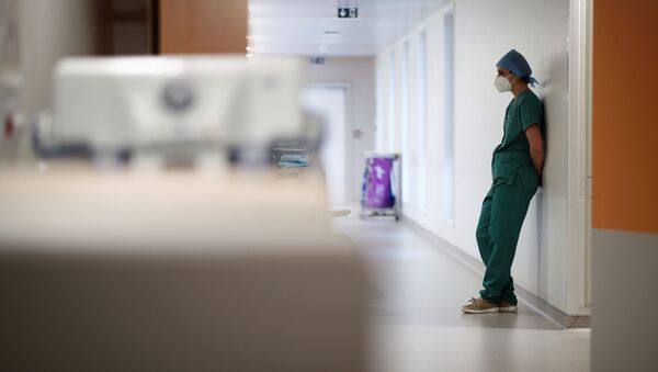 A medical staff member works in the Intensive Care Unit (ICU) where patients suffering from the coronavirus disease (COVID-19) are treated at the Melun-Senart hospital, near Paris, France, November 20, 2020 - Sputnik International