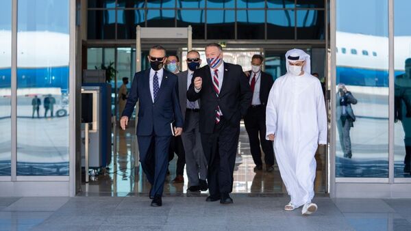 US Secretary of State Mike Pompeo walks and talks with US and UAE officials during a visit to the country as part of a multi-nation trip to the region. November 2020. - Sputnik International