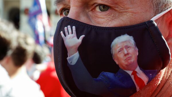 Doug Roman wearing a US President Donald Trump protective mask takes part in a protest against the results of the 2020 presidential election in Atlanta, Georgia, US, 21 November 2020. - Sputnik International