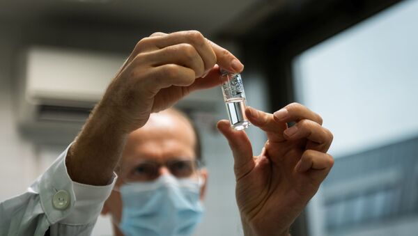 A laboratory assistant holds a tube with Russia's Sputnik-V vaccine against the coronavirus disease (COVID-19) at the National Institute of Pharmacy and Nutrition in Budapest, Hungary, November 19, 2020. - Sputnik International