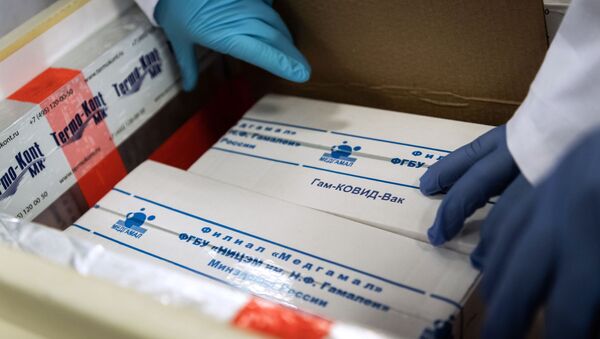 In this handout photo released by Hungarian Foreign Ministry, laboratory assistants unpack Russia's coronavirus vaccine Gam-COVID-Vac, trade-named Sputnik V, in Budapest, Hungary - Sputnik International