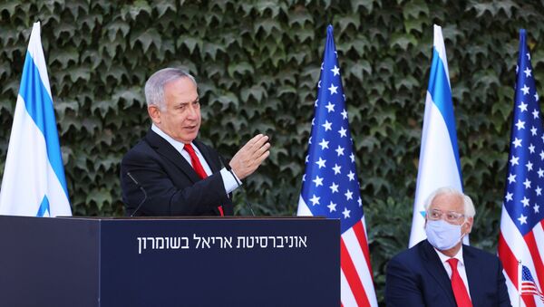 Israeli Prime Minister Benjamin Netanyahu gestures during a special ceremony with the U.S. Ambassador to Israel David Friedman to sign an extension of the Israel-U.S. scientific cooperation agreement in “Judea, Samaria” (the biblical names for the West Bank) and the Golan Heights, at Ariel University in the Jewish settlement of Ariel, in the Israeli-occupied West Bank October 28, 2020. Emil Salman/Pool via REUTERS - Sputnik International