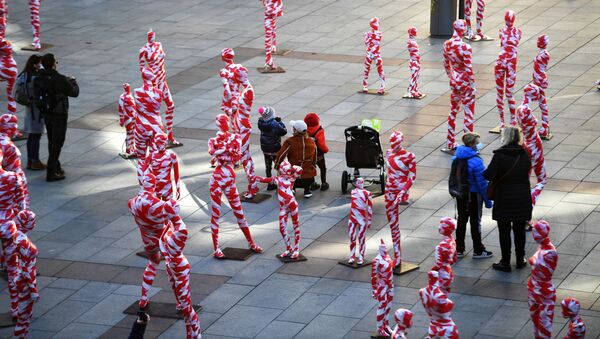 People stand in-between an art installation with 111 mannequins on Marienplatz calling for more mindfulness and appreciation in times of corona as the spread of the coronavirus disease (COVID-19) continues in Munich, Germany, November 18, 2020 - Sputnik International