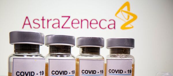 Vials with a sticker reading, COVID-19 / Coronavirus vaccine / Injection only and a medical syringe are seen in front of a displayed AstraZeneca logo in this illustration taken October 31, 2020. Vials with a sticker reading, COVID-19 / Coronavirus vaccine / Injection only and a medical syringe are seen in front of a displayed AstraZeneca logo in this illustration taken October 31, 2020. - Sputnik International
