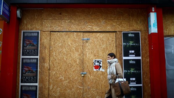 A woman walks past a boarded up London shop, amid the outbreak of the coronavirus disease (COVID-19), at Oxford Street, in London, Britain, October 14, 2020.  - Sputnik International
