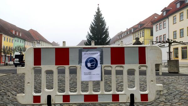 A placard reminds people to wear a protective mask and keep distance at the weekly market, as the spread of the coronavirus disease (COVID-19) continues in Hildburghausen, Germany, November 26, 2020. The state premier of Thuringia on Thursday announced a first mass test for children and teenagers in the district of Hildburghausen, Germany's coronavirus hotspot, to find out to what extent they contribute to a rapid surge in infections.  - Sputnik International