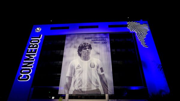 A picture of soccer legend Diego Maradona hangs in the front of the CONMEBOL headquarters following the death of Maradona, in Luque, Paraguay November 26, 2020.  - Sputnik International