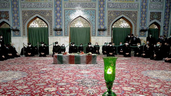 Servants of the holy shrine of Imam Reza sit near the coffin of Iranian nuclear scientist Mohsen Fakhrizadeh, in Mashhad, Iran November 29, 2020. - Sputnik International