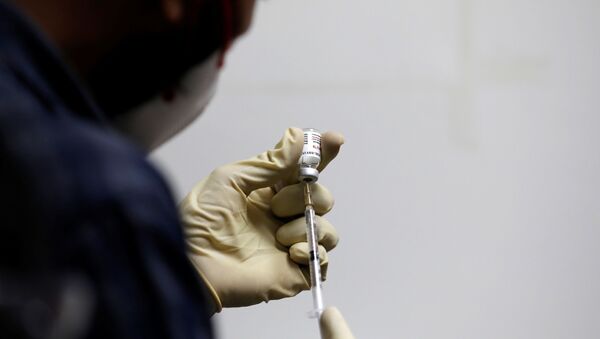 A medic fills a syringe with COVAXIN, an Indian government-backed experimental COVID-19 vaccine, before administering it to a health worker during its trials, at the Gujarat Medical Education and Research Society in Ahmedabad, India, 26 November 2020. - Sputnik International