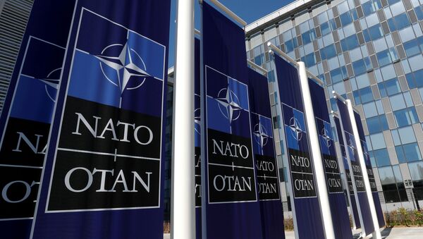 Banners displaying the NATO logo are placed at the entrance of new NATO headquarters during the move to the new building, in Brussels, Belgium April 19, 2018. - Sputnik International