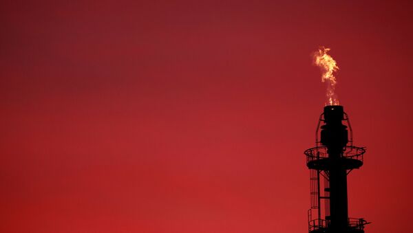 Flames come out of a chimney at the French oil giant Total Refinery during sunset in Donges, France, November 30, 2020. - Sputnik International