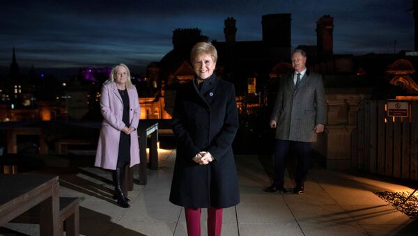 Scotland's First Minister Nicola Sturgeon flanked by Scottish National Investment Bank CEO Eilidh Mactaggart and Chair Willie Watt pose at the bank's official launch at their headquarters in Edinburgh, Scotland, Britain November 19, 2020.  - Sputnik International
