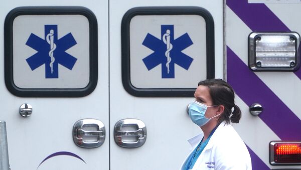 A health care professional walks past an ambulance during the coronavirus disease (COVID-19) pandemic in the Manhattan borough of New York City, New York, U.S., November 13, 2020 - Sputnik International