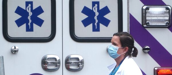 A health care professional walks past an ambulance during the coronavirus disease (COVID-19) pandemic in the Manhattan borough of New York City, New York, U.S., November 13, 2020 - Sputnik International