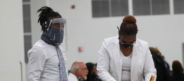 A person reviews ballots as votes continue to be counted at the TCF Center the day after the 2020 U.S. presidential election, in Detroit, Michigan, U.S., November 4, 2020.  REUTERS/Shannon Stapleton - Sputnik International