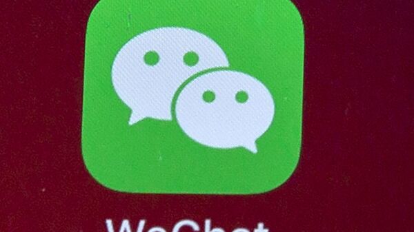Icons for the smartphone apps WeChat are seen on a smartphone screen in Beijing, on Aug. 7, 2020.  The Justice Department is asking a judge to allow WeChat to be banned from app stores in the U.S., pending an appeal. In a Friday, Sept. 25, 2020 filing, the Justice Department requested U.S. Magistrate Judge Laurel Beeler in California put on hold a preliminary injunction issued Saturday.  - Sputnik International