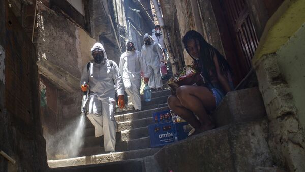Volunteers spray disinfectant in an alley to help contain the spread of the new coronavirus, at the Santa Marta slum in Rio de Janeiro, Brazil, Saturday, Nov. 28, 2020.  - Sputnik International