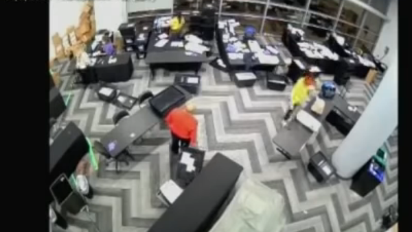 Screenshot from the video allegedly showing election staffers in Fulton County, Atlanta, Georgia, staying behind and pulling out boxes of extra ballots - Sputnik International