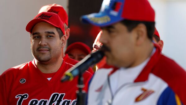 FILE PHOTO: Nicolas Maduro Guerra, son of Venezuela’s President Nicolas Maduro and member of the National Constituent Assembly, looks as his father talks to the media before a softball game with ministers and military high command members at Fuerte Tiuna military base, in Caracas, Venezuela January 28, 2018.  - Sputnik International