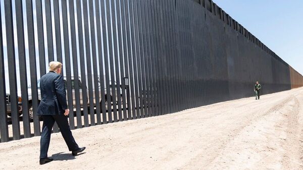 President Donald Trump walks along the completed 200th mile of new border wall on June 23, 2020, along the U.S.-Mexico border near Yuma, Arizona. - Sputnik International