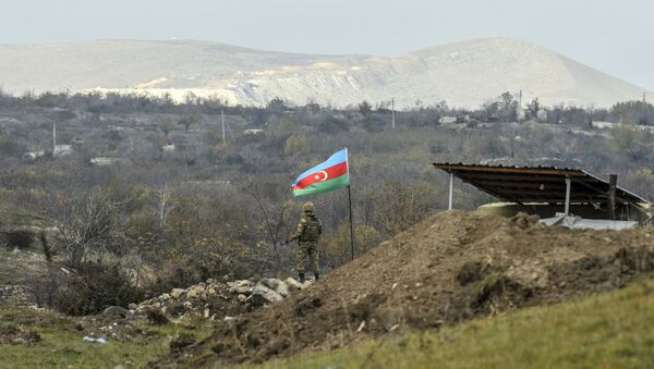 An Azerbaijani soldier stands guard at a checkpoint on a road entering Fizuli from Hadrut on December 2, 2020, a day after Baku's army entered the final district given up by Armenia under a peace deal that ended weeks of fighting over the disputed Nagorno-Karabakh region.  - Sputnik International