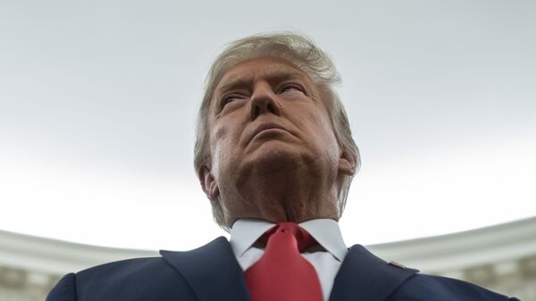 President Donald Trump listens during a ceremony to present the Presidential Medal of Freedom to former football coach Lou Holtz, in the Oval Office of the White House, Thursday, Dec. 3, 2020 - Sputnik International