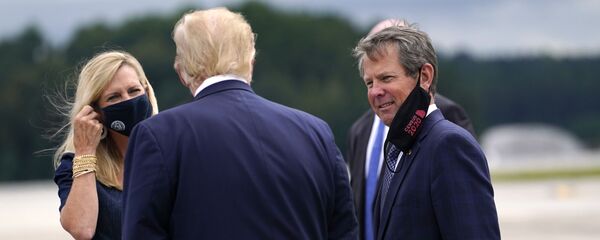 President Donald Trump greets Georgia Gov. Brian Kemp and his wife Marty as he arrives at Dobbins Air Reserve Base for a campaign event at the Cobb Galleria Centre, 25 September 2020, in Atlanta. - Sputnik International