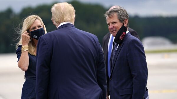 President Donald Trump greets Georgia Gov. Brian Kemp and his wife Marty as he arrives at Dobbins Air Reserve Base for a campaign event at the Cobb Galleria Centre, 25 September 2020, in Atlanta. - Sputnik International