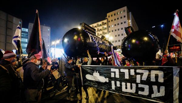 Demonstrators hold up inflatable submarines, flags and signs during a protest against Israeli Prime Minister Benjamin Netanyahu's alleged corruption and his handling of the coronavirus disease (COVID-19) crisis, near Netanyahu's official residence in Jerusalem, December 5, 2020.  - Sputnik International