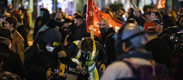 Members of Antifa and the Proud Boys clash in the middle of the street following the Million MAGA March on 14 November in Washington, DC. - Sputnik International