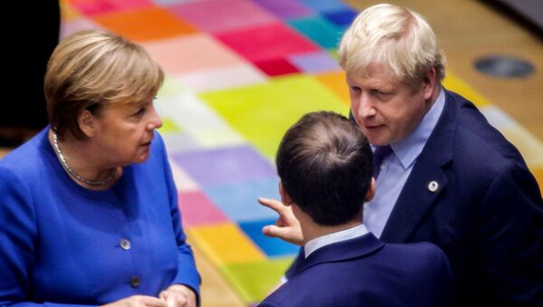 British Prime Minister Boris Johnson (R), French President Emmanuel Macron (C) and German Chancellor Angela Merkel (L) speak upon their arrival for a round table meeting as part of a European Union summit at European Union Headquarters in Brussels on October 17, 2019. - Sputnik International