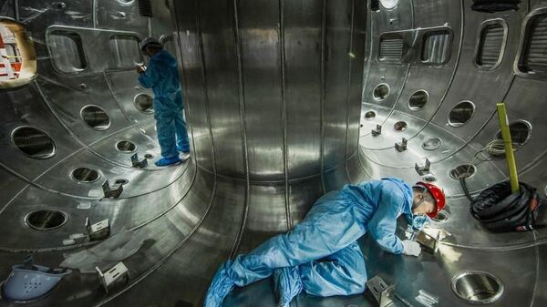 File photo taken on May 27, 2019 shows staff members of China National Nuclear Corporation (CNNC) Southwestern Institute of Physics working in the vacuum chamber of the HL-2M Tokamak, China's new-generation artificial sun, in Chengdu, southwest China's Sichuan Province. - Sputnik International