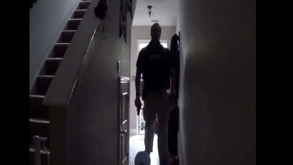 Screenshot captures an uScreenshot captures an unidentified law enforcement official walking through the home of Rebekah Jones, a data scientist who was dismissed from the Florida Department of Health over alleged insubordination. A raid was conducted at Jones' residence in response to a complaint issued by her former employer in early November.nidentified law enforcement official walking through the home of Rebekah Jones, a former data scient - Sputnik International