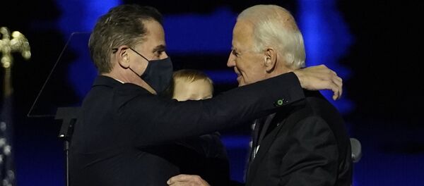 US President-elect Joe Biden (R) embraces his son Hunter Biden (L) on stage after delivering remarks in Wilmington, Delaware, on 7 November 2020.  - Sputnik International