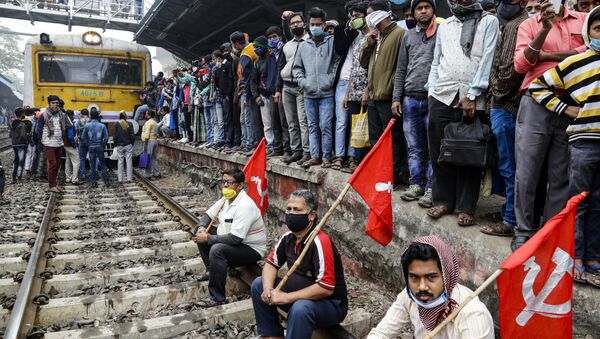 Left party supporters black a railway track during a nationwide shutdown called by thousands of Indian farmers protesting new agriculture laws in Kolkata, India, Tuesday, Dec. 8, 2020 - Sputnik International