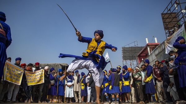 A nihang or a Sikh warrior displays his Sikh martial art skills during a nationwide shutdown called by thousands of Indian farmers protesting new agriculture laws, at the Delhi-Haryana state border, India, Tuesday, Dec. 8, 2020 - Sputnik International