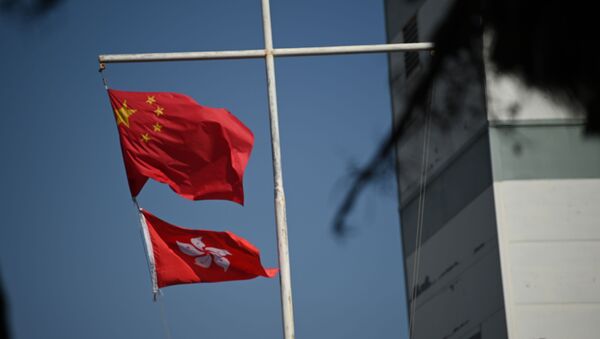 The Chinese (top) and Hong Kong flags flutter in Hong Kong on December 5, 2020.  - Sputnik International