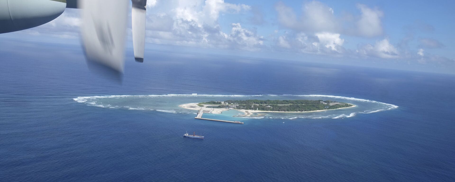 An aerial view shows a vessel preparing for a search-and-rescue exercise off Taiping island, in the South China Sea , Tuesday, Nov. 29, 2016, as part of efforts to cement its claim to a key island in the strategically vital waterbody. Eight vessels and three aircraft took part in Tuesday's drill, which simulated a fire aboard a cargo ship that forced crew members to seek safety on Taiping in the Spratly island group. - Sputnik International, 1920, 21.03.2022