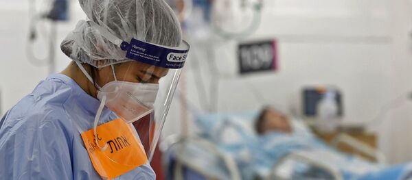 A member of the medical staff wearing protective gear works at the coronavirus ward of the Rambam Health Care Campus, initially built as an underground medical facility before being converted to a car park, then to a center to receive patients as COVID-19 cases surge, in the northern Israeli city of Haifa on October 11, 2020.  - Sputnik International