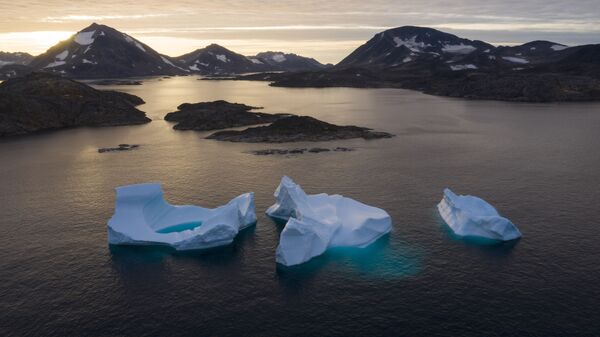 In this Aug. 16, 2019 file photo, icebergs float away as the sun rises near Kulusuk, Greenland - Sputnik International