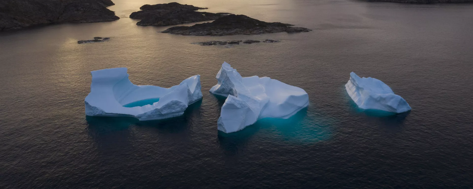 In this Aug. 16, 2019 file photo, icebergs float away as the sun rises near Kulusuk, Greenland - Sputnik International, 1920, 10.01.2025