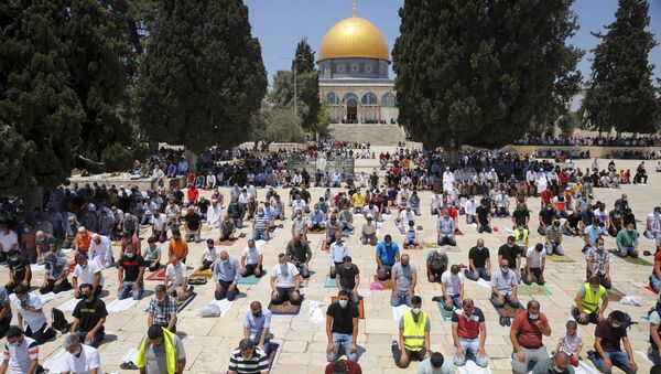 Muslim men keep social distancing to prevent the spread of coronavirus pandemic during Friday prayer, next to the Dome of the Rock Mosque in the Al Aqsa Mosque compound in Jerusalem's old city, Friday, July 10, 2020 - Sputnik International
