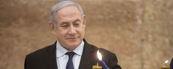 Israeli Prime Minister Benjamin Netanyahu, lights a Hanukkah candle at the Western Wall, the holiest site where Jews can pray in Jerusalem's old city, Sunday, 22 December 2019. - Sputnik International